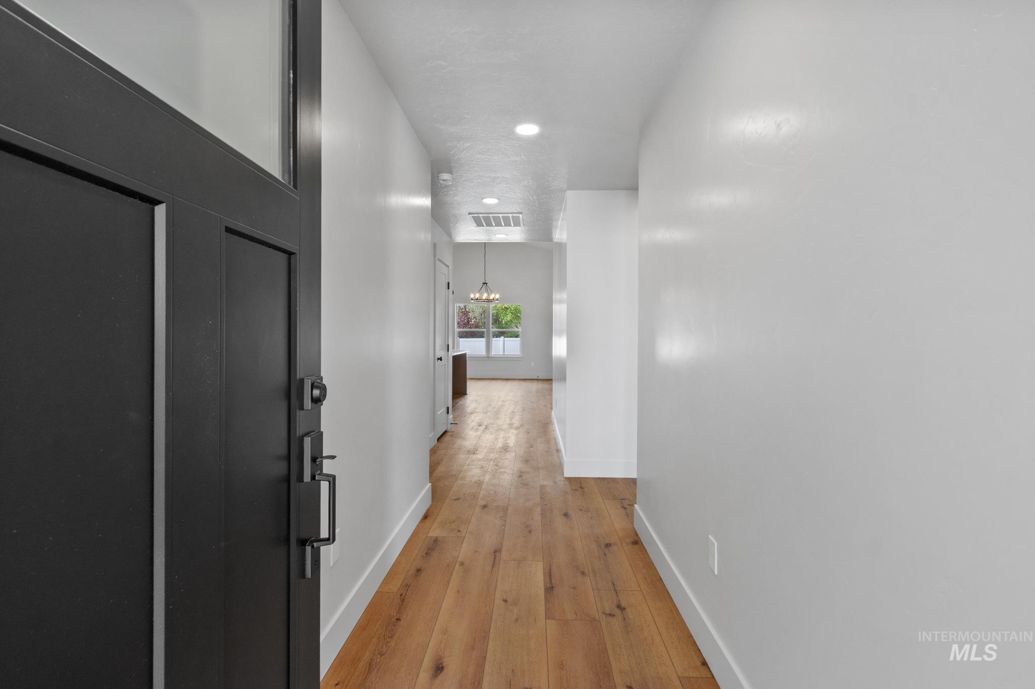 321 North 11th Street Parma, ID 83660 - Photo 2 of 36 Entryway with wood-finish flooring, white walls, and recessed lighting