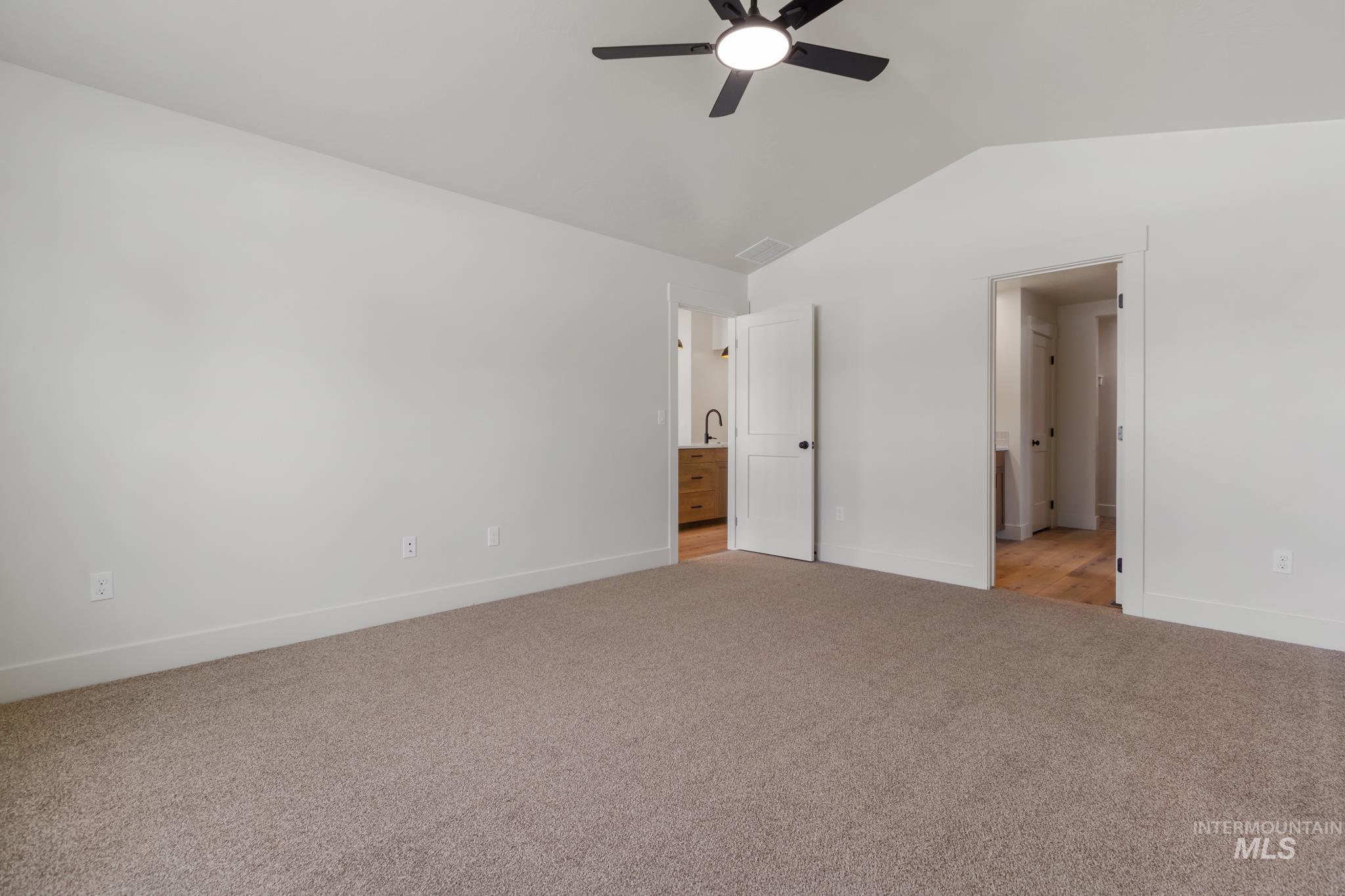 321 North 11th Street Parma, ID 83660 - Photo 25 of 36 Carpeted room featuring a vaulted ceiling and a black ceiling fan with integrated lighting