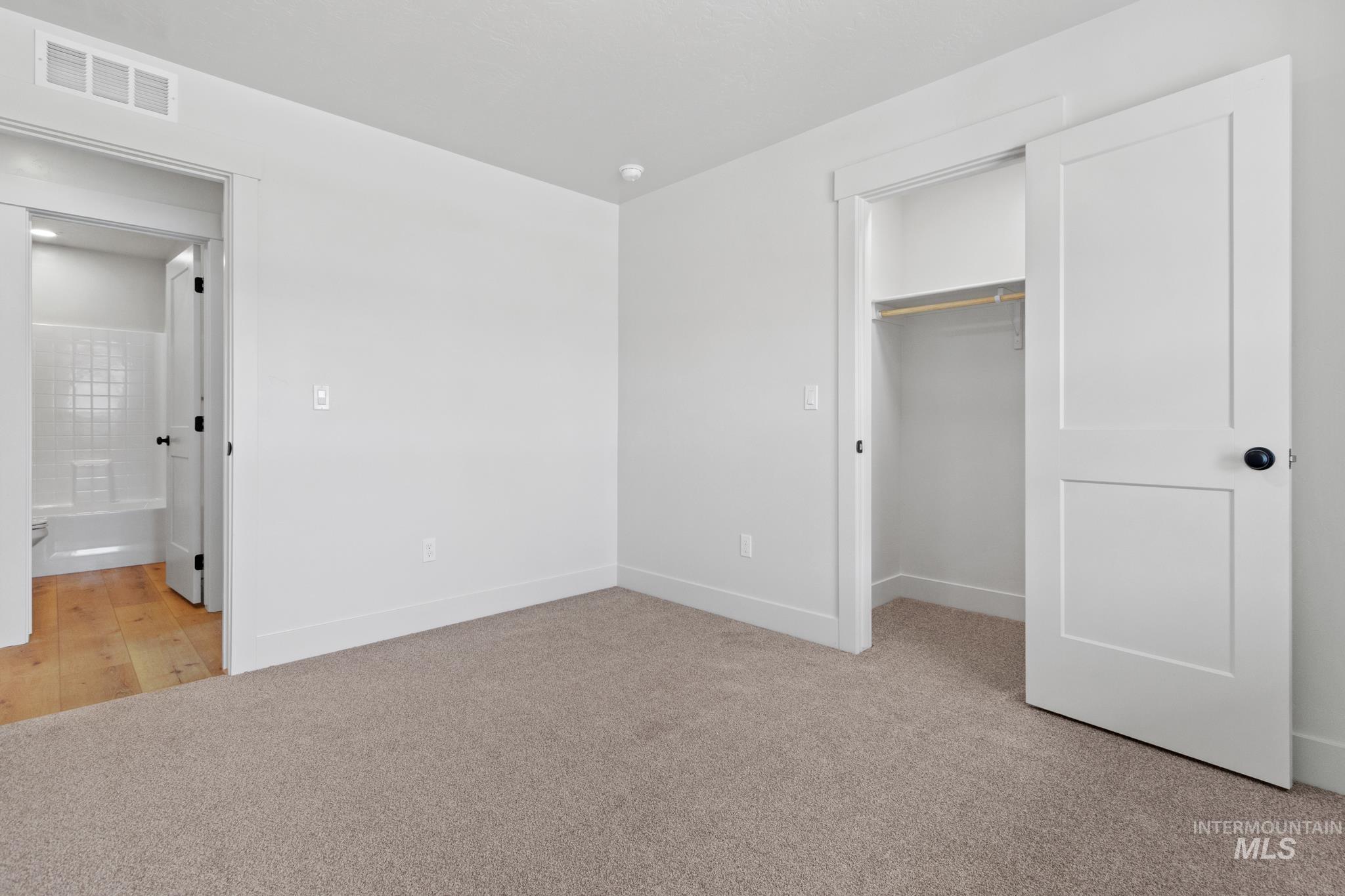 321 North 11th Street Parma, ID 83660 - Photo 5 of 36 Neutral-toned carpeting throughout