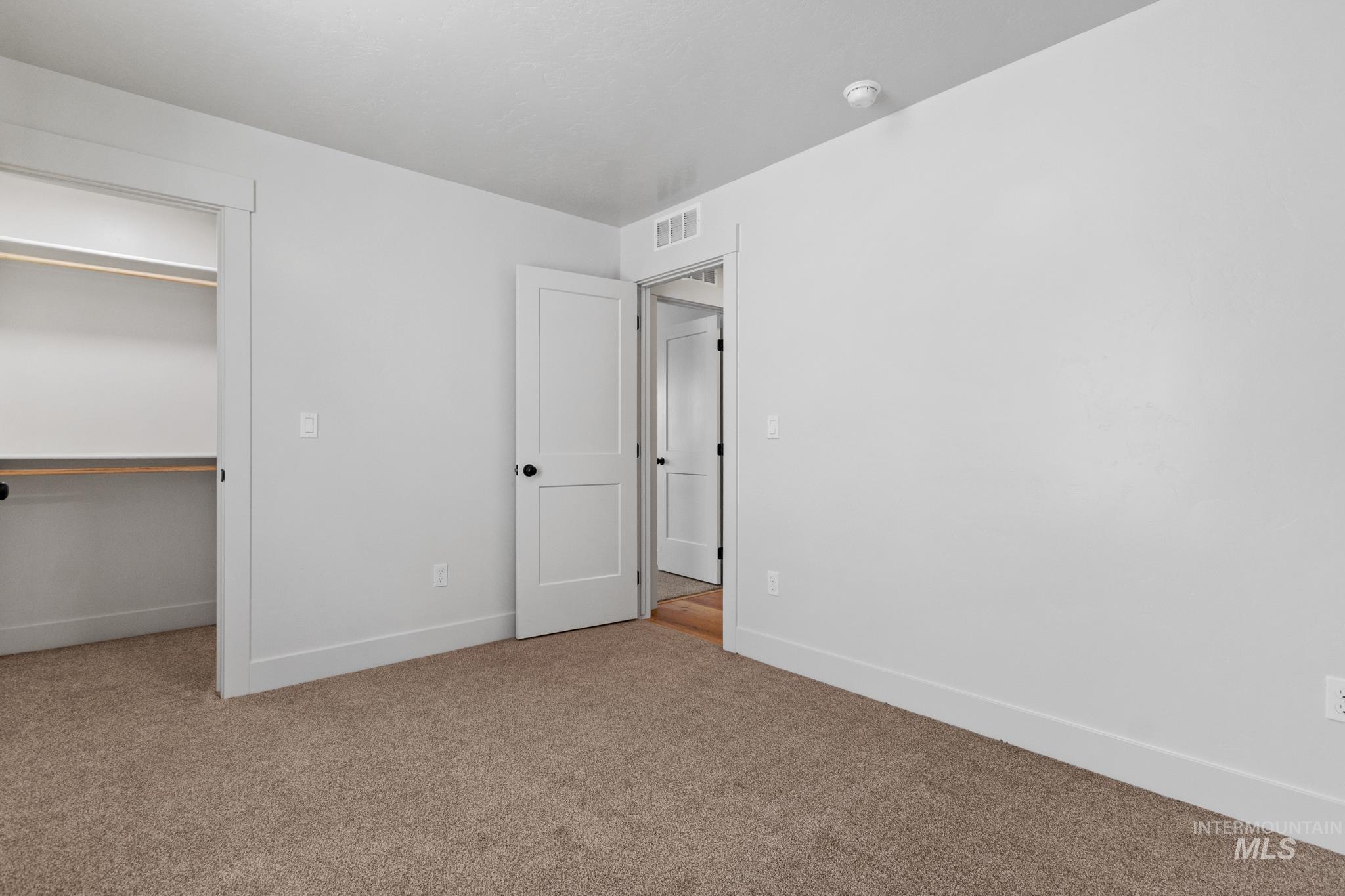 321 North 11th Street Parma, ID 83660 - Photo 7 of 36 Carpeted room featuring a built-in closet with shelving and hanging rods