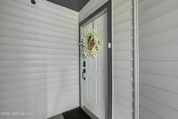 a kitchen with granite countertop a stove a kitchen island a dining table and chairs with wooden floor