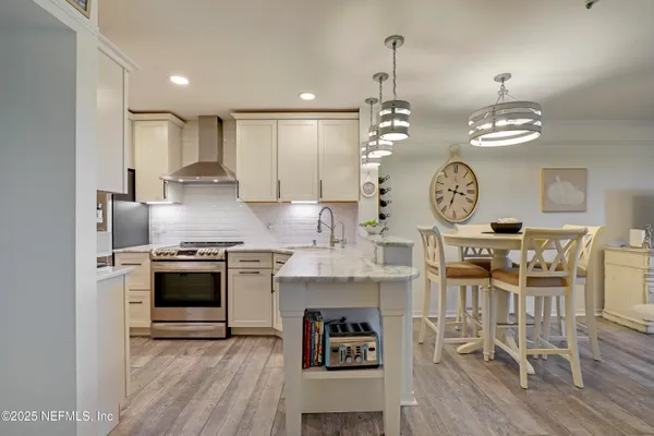 a kitchen with refrigerator and cabinets