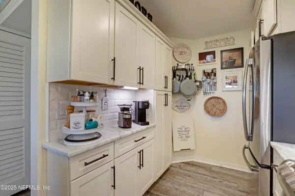 a kitchen with cabinets and stainless steel appliances