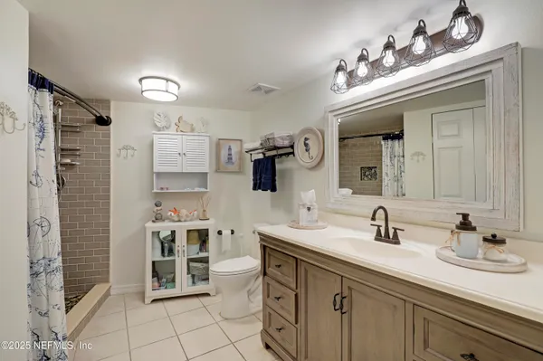 a spacious bathroom with a sink and a mirror