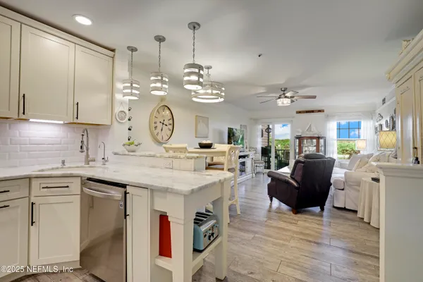 a kitchen with cabinets and wooden floor