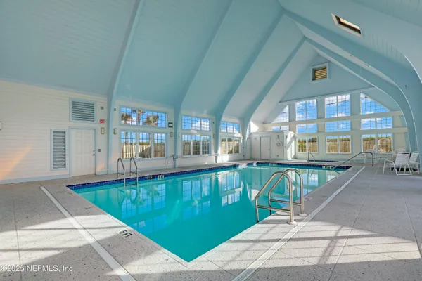 a view of a balcony with dining table and chairs