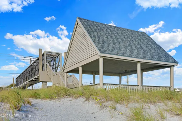 a view of a patio with a table and chairs and potted plants