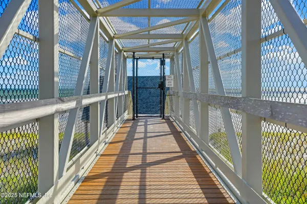 a view of a patio with table and chairs potted plants and large tree