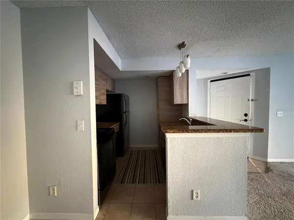 a kitchen with a refrigerator and a stove
