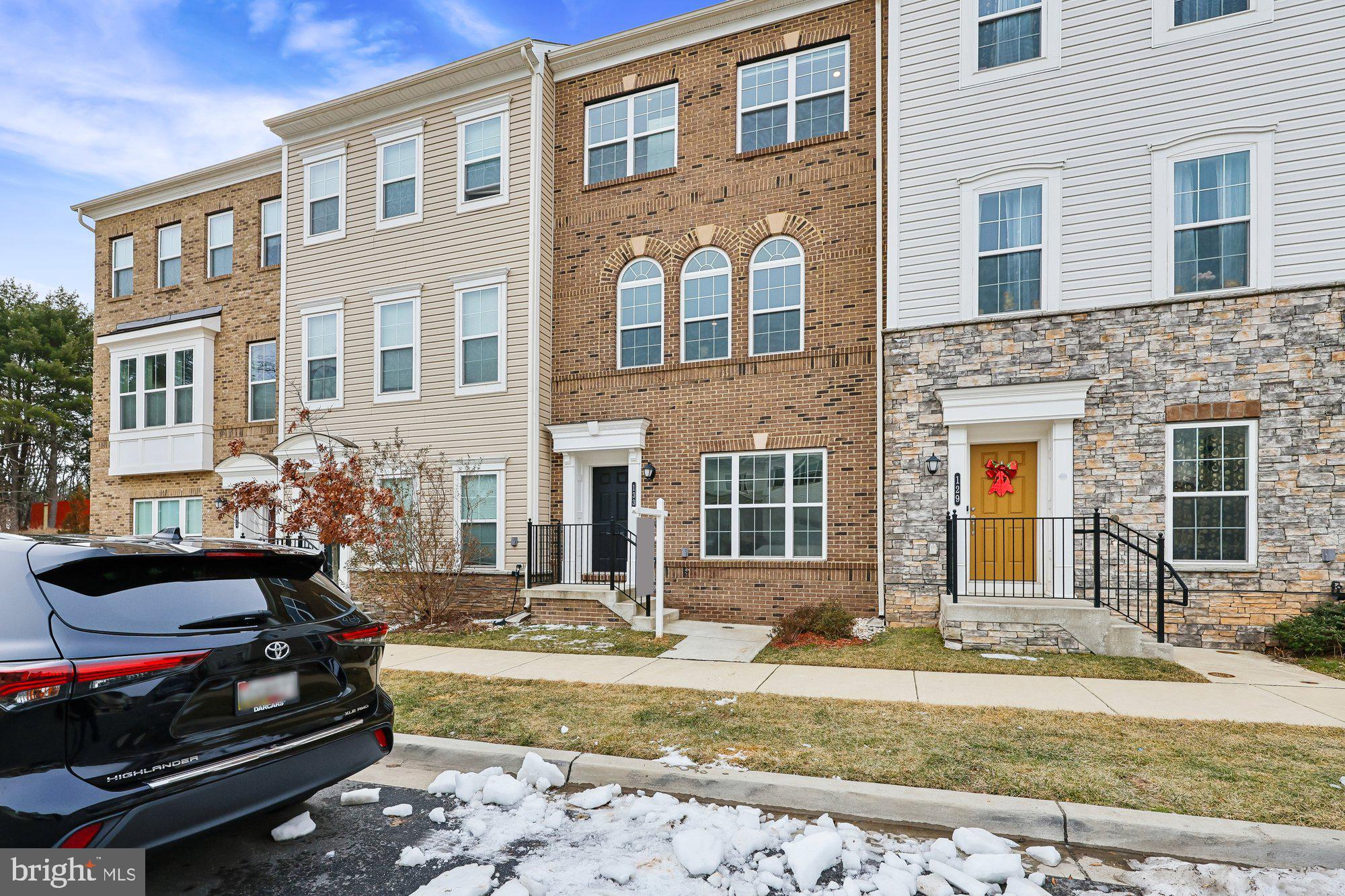 133 Flower Center Lane Gaithersburg, MD 20878 - Photo 1 of 1 a front view of a house with a yard fire pit and couches chairs