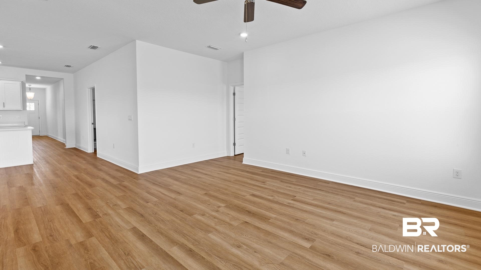 12931 Grand Rpds Road Fairhope, AL 36532 - Photo 19 of 33 Empty room featuring visible vents, light wood-type flooring, and baseboards