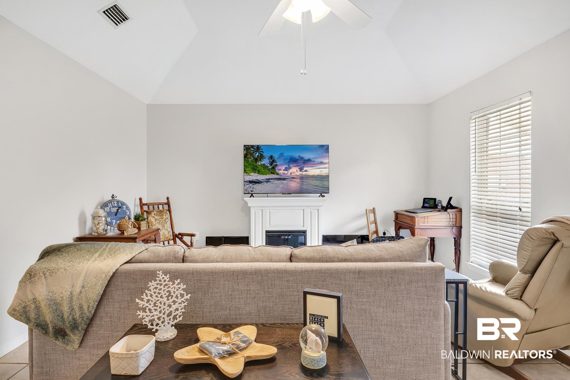 105 Cluster Oaks Court Foley, AL 36535 - Photo 9 of 26 Living area featuring lofted ceiling, a glass covered fireplace, a ceiling fan, and light tile patterned floors