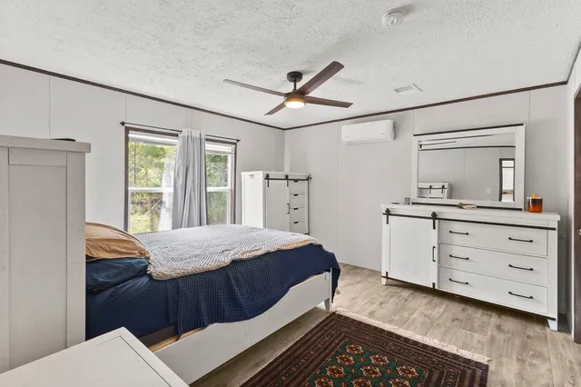 a bedroom with a bed and a dresser