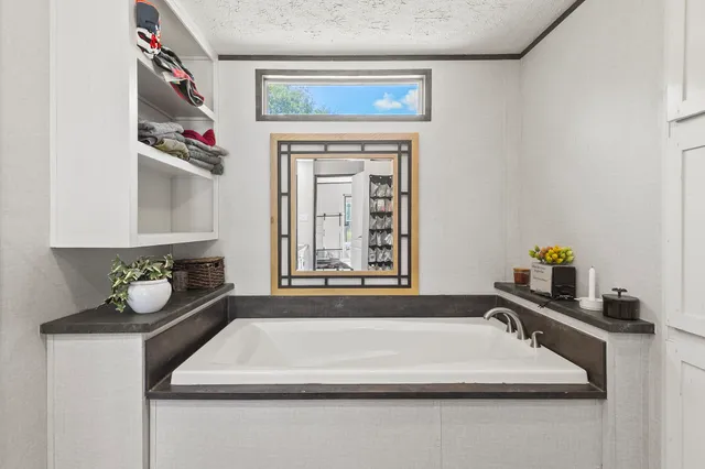 a bathroom with a granite countertop sink a vanity and a bathtub