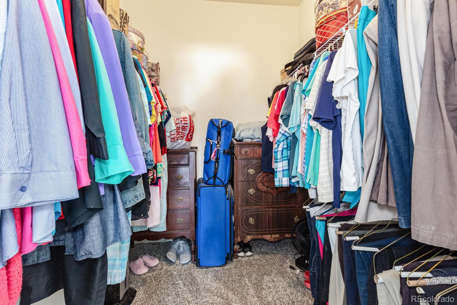8425 Pebble Creek Way, Unit 104 Highlands Ranch, CO 80126 - Photo 13 of 16 a view of walk in closet with clothes