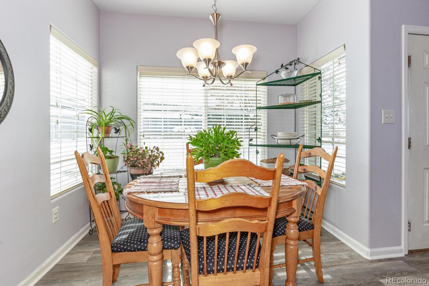 8425 Pebble Creek Way, Unit 104 Highlands Ranch, CO 80126 - Photo 6 of 16 a view of a dining room with furniture and chandelier