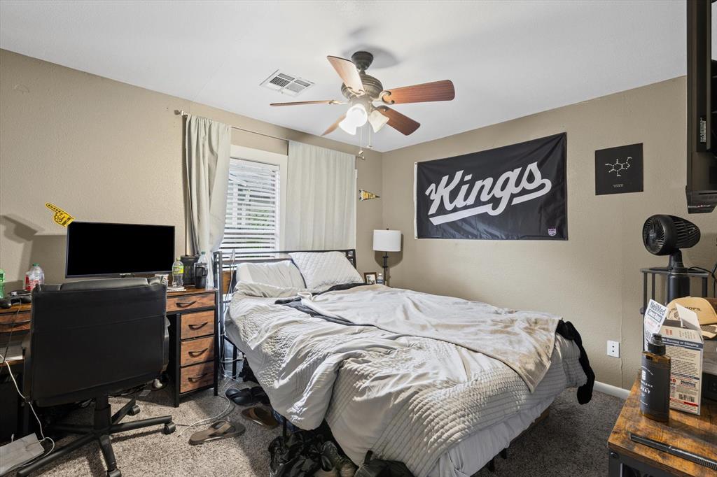 2007 South 7th Street Waco, TX 76706 - Photo 10 of 22 a bedroom with a bed and a flat screen tv