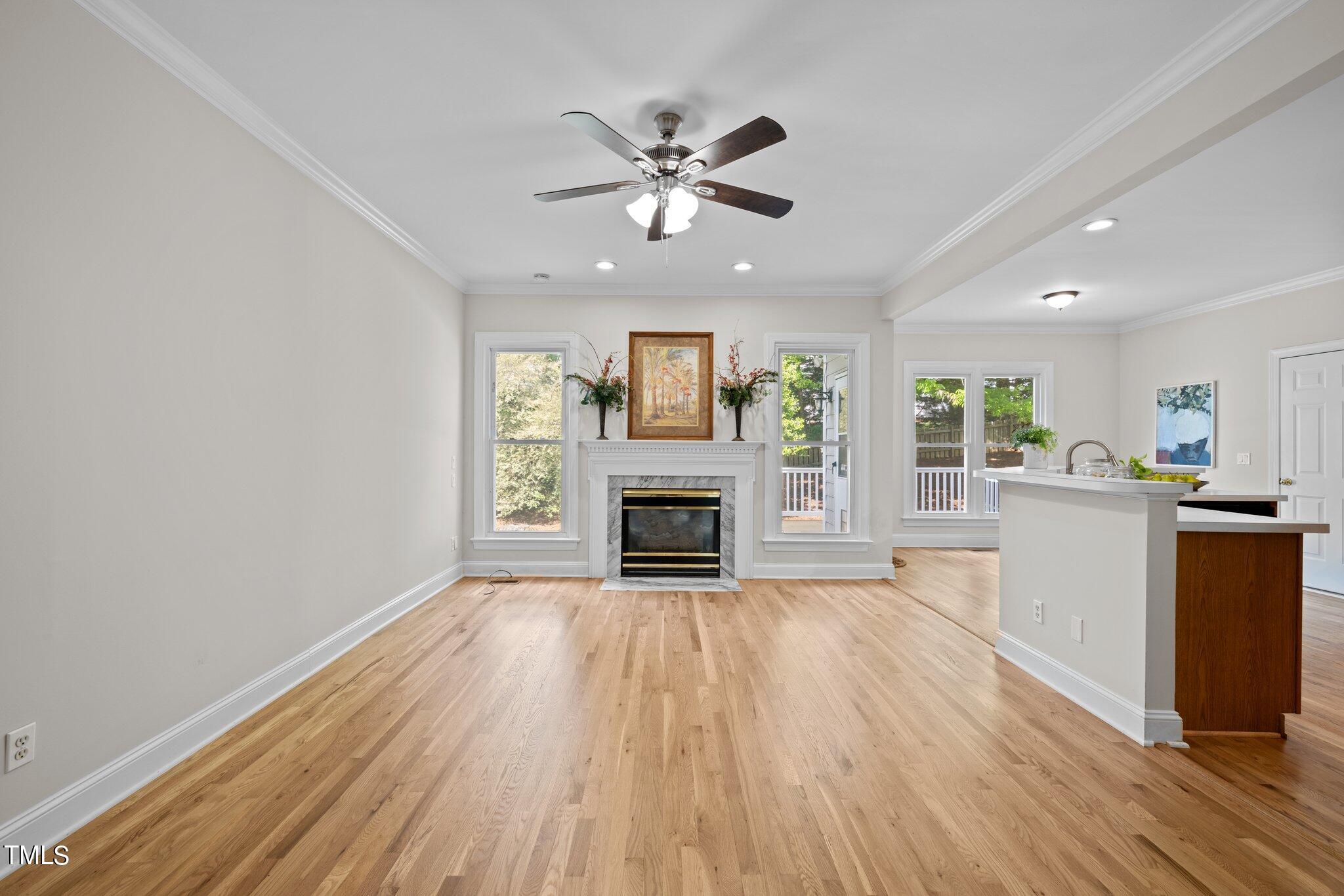 5236 Covington Bend Drive Raleigh, NC 27613 - Photo 8 of 49 wooden floor fireplace and windows in an empty room