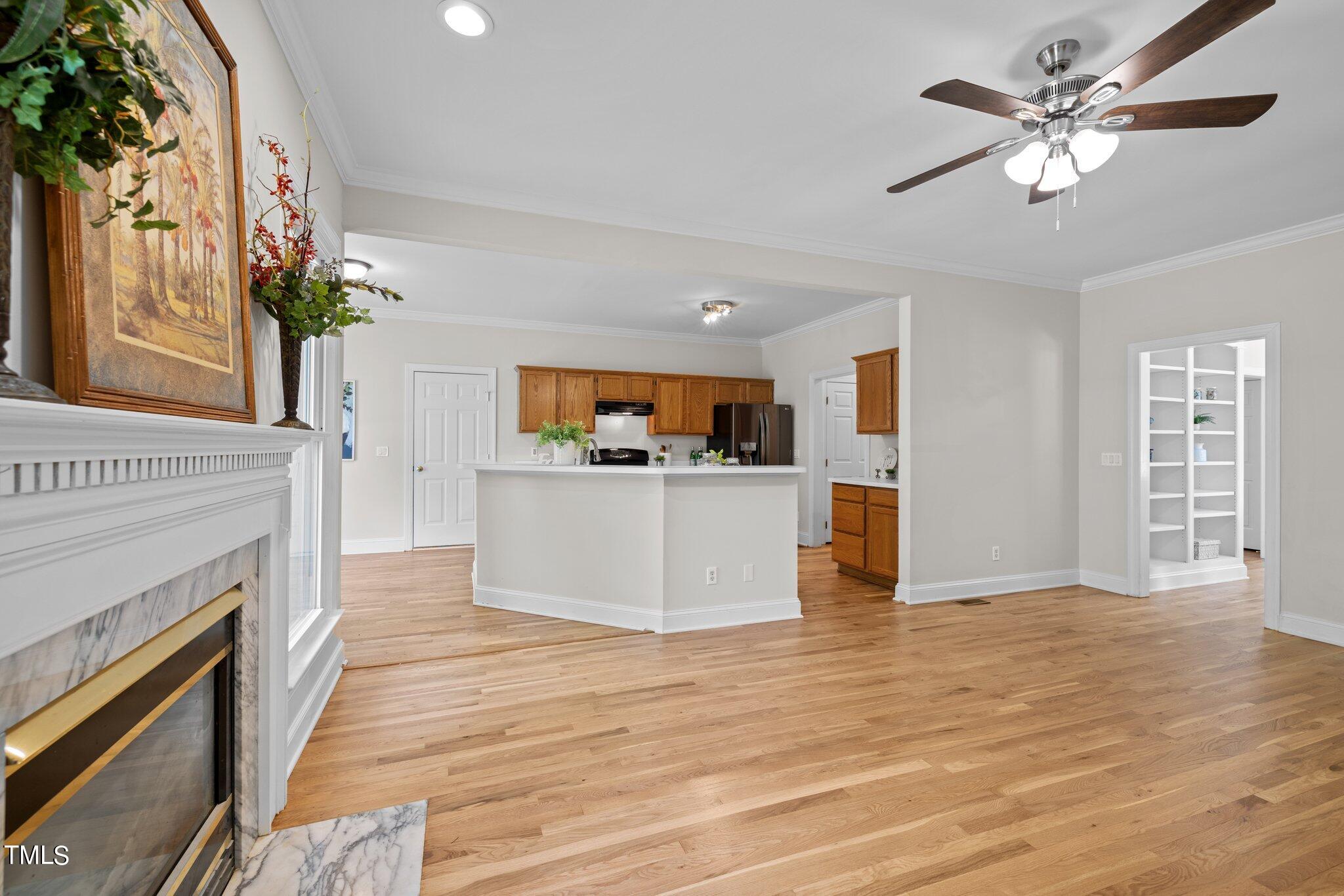 5236 Covington Bend Drive Raleigh, NC 27613 - Photo 10 of 49 a view of a kitchen with furniture a ceiling fan and wooden floor