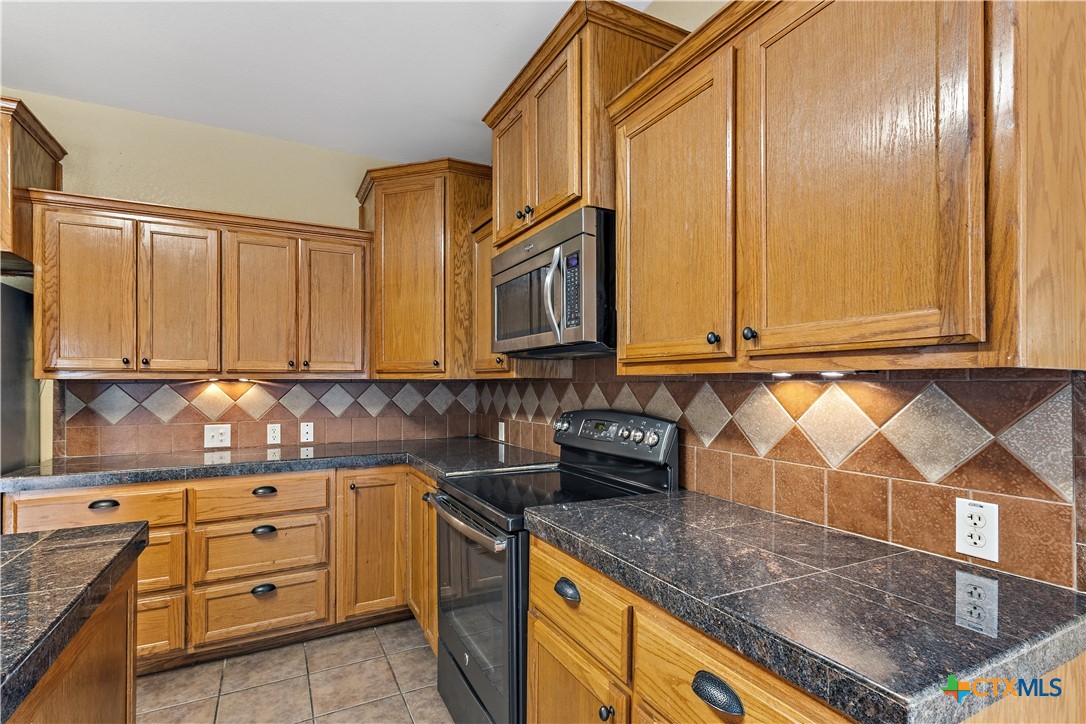 283 County Road 4710 Kempner, TX 76539 - Photo 17 of 47 a kitchen with stainless steel appliances granite countertop a sink and cabinets