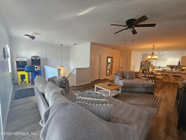 a living room with furniture and kitchen view