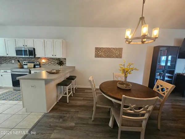a kitchen with a dining table and chairs