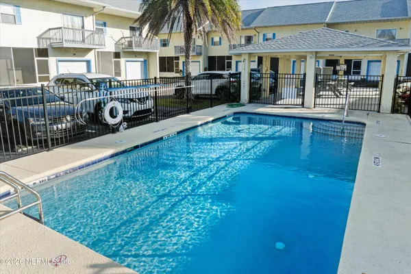 a swimming pool view with a outdoor seating