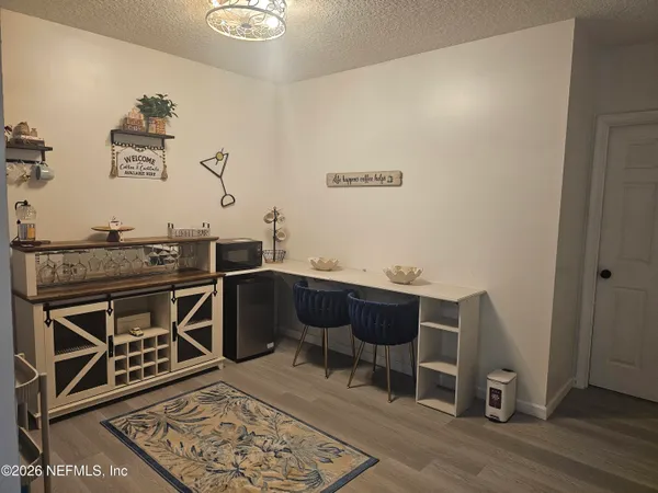 a living room with a couch and wooden floor