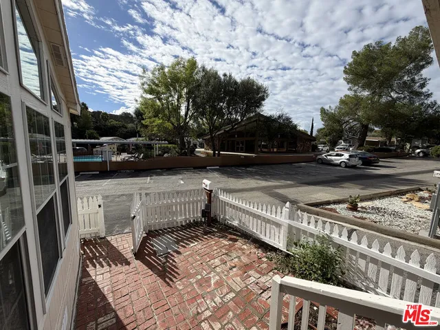 a view of balcony with wooden floor and fence