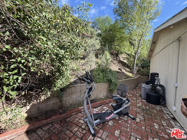 a backyard of a house with chairs and a fire pit