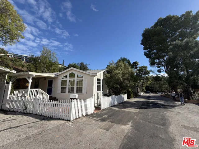 a view of a house with a yard and porch