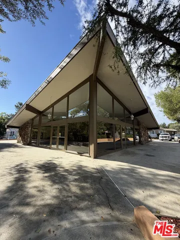 a swimming pool with a outdoor seating and yard