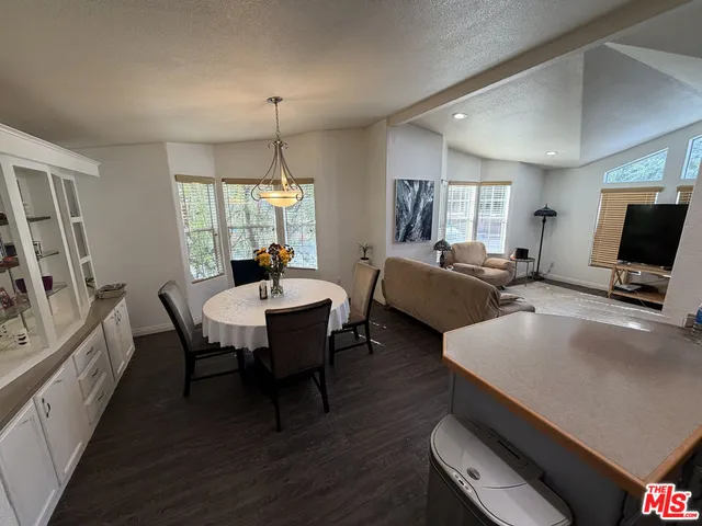 a living room with furniture a window and a flat screen tv