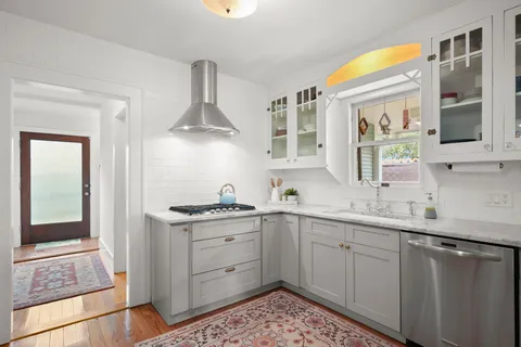a kitchen with a sink stove and cabinets