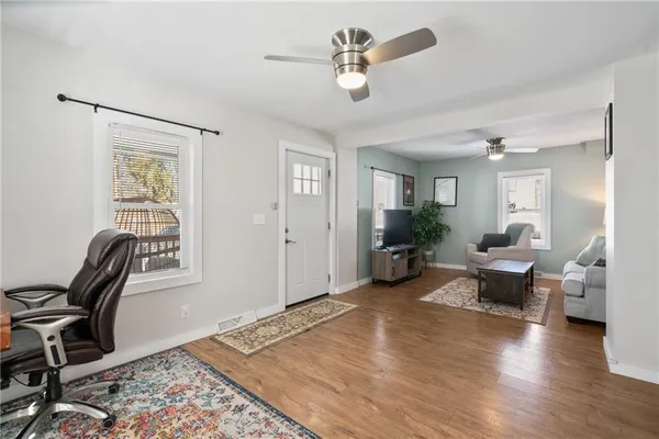 a living room with furniture and wooden floor