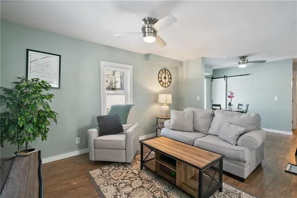 a living room with furniture and a potted plant