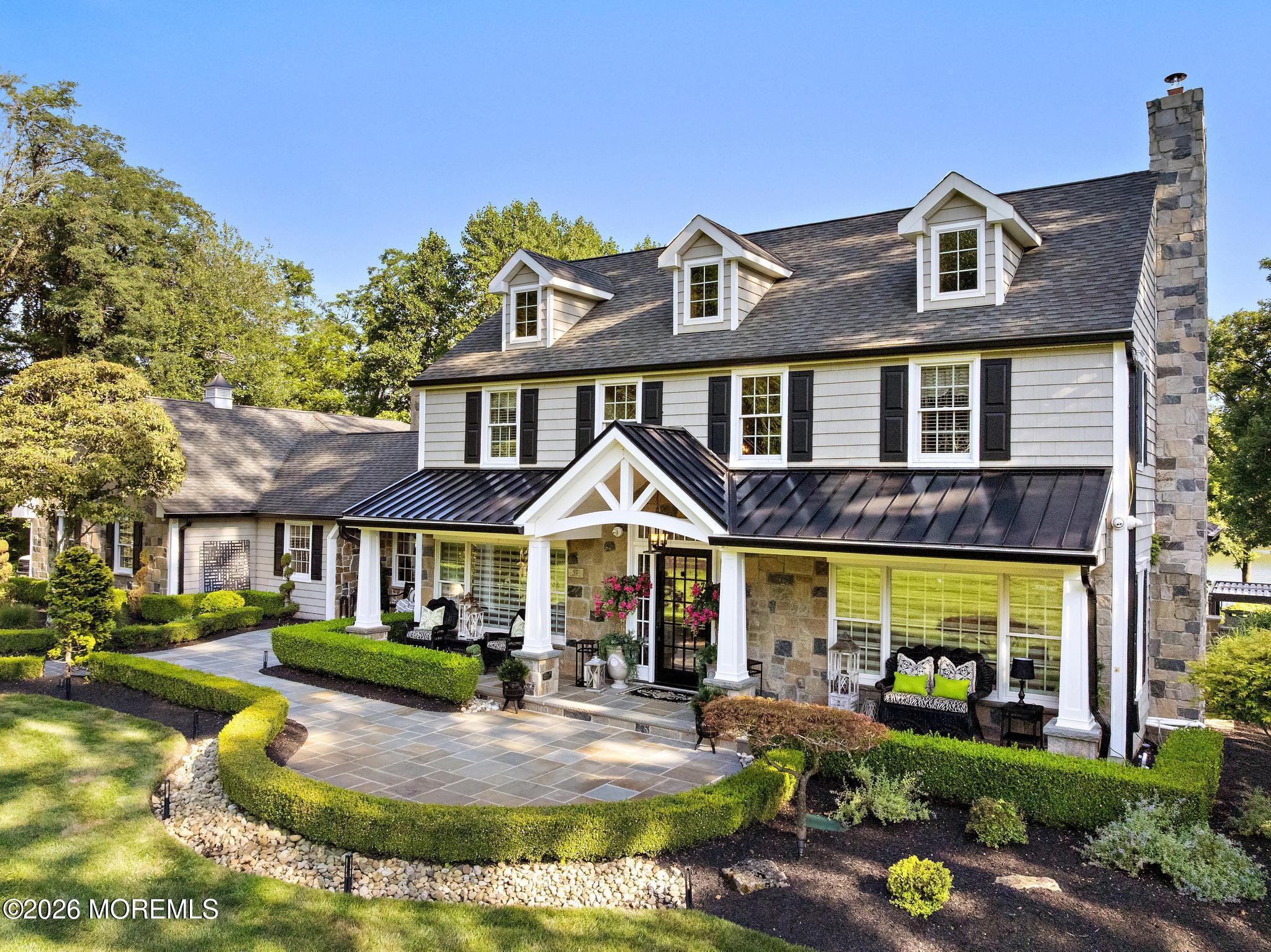 a front view of a residential apartment building with swimming pool and porch