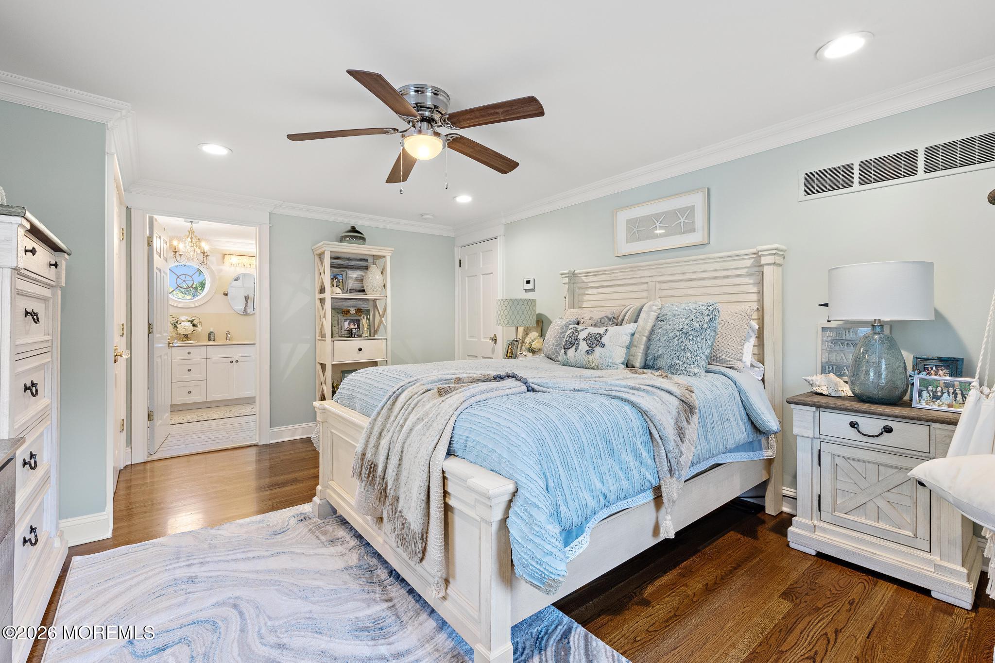57 Beaver Dam Road Colts Neck, NJ 07722 - Photo 12 of 79 a spacious bedroom with a large bed and a chandelier
