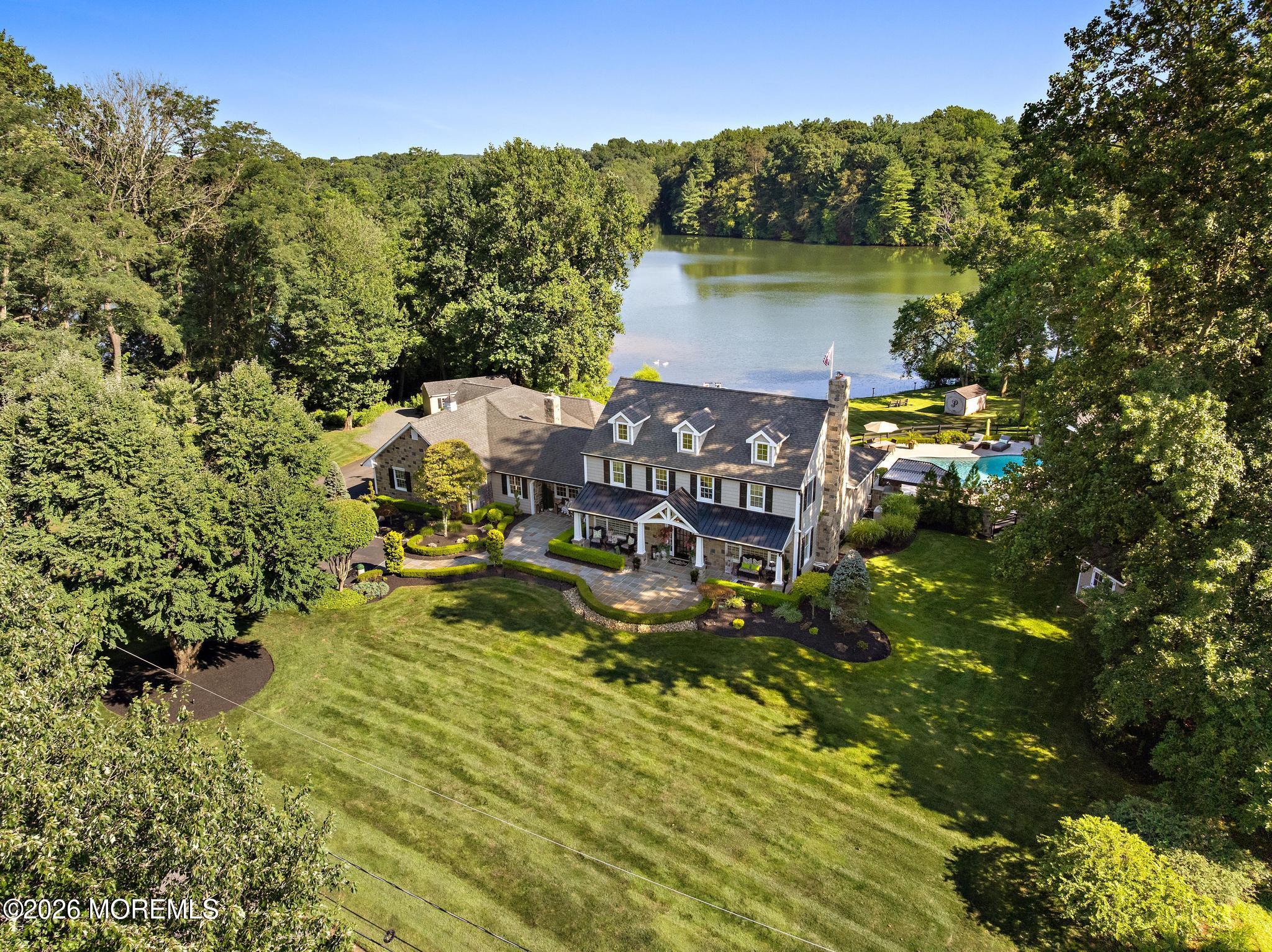 57 Beaver Dam Road Colts Neck, NJ 07722 - Photo 2 of 79 a view of a lake with a mountain in the background