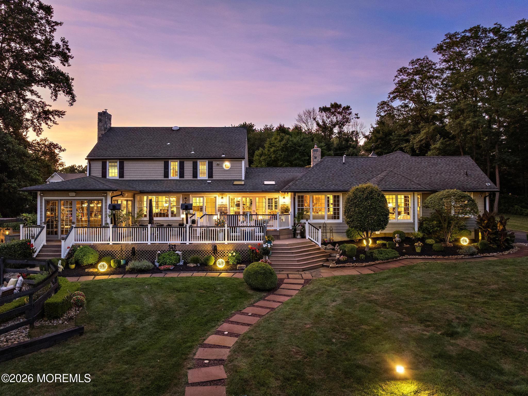 57 Beaver Dam Road Colts Neck, NJ 07722 - Photo 47 of 79 a view of a big yard with table and chairs under an umbrella