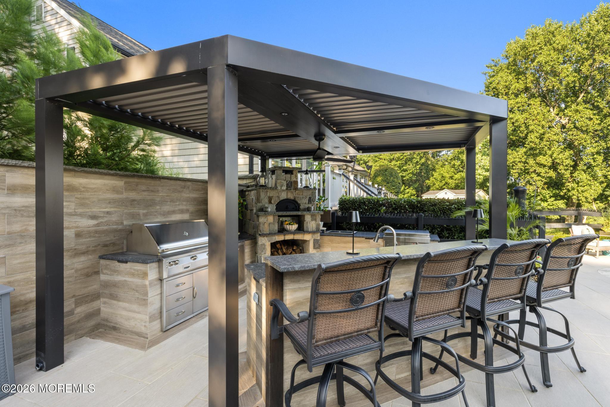 57 Beaver Dam Road Colts Neck, NJ 07722 - Photo 50 of 79 a view of an outdoor dining space with a table and chairs