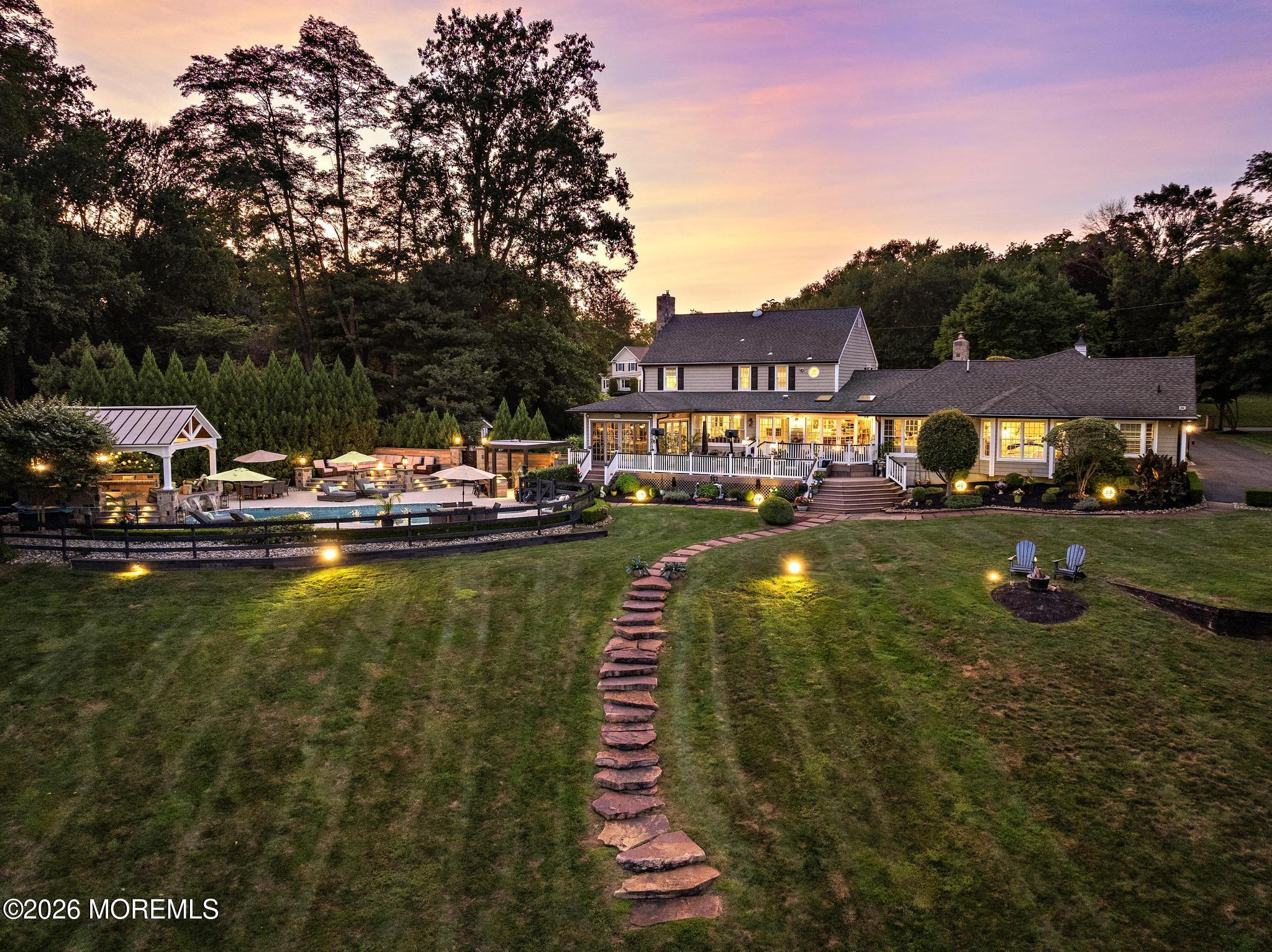 57 Beaver Dam Road Colts Neck, NJ 07722 - Photo 73 of 79 a view of swimming pool with outdoor seating and trees in the background