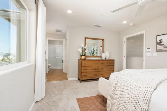 a bedroom with a bed and a dresser