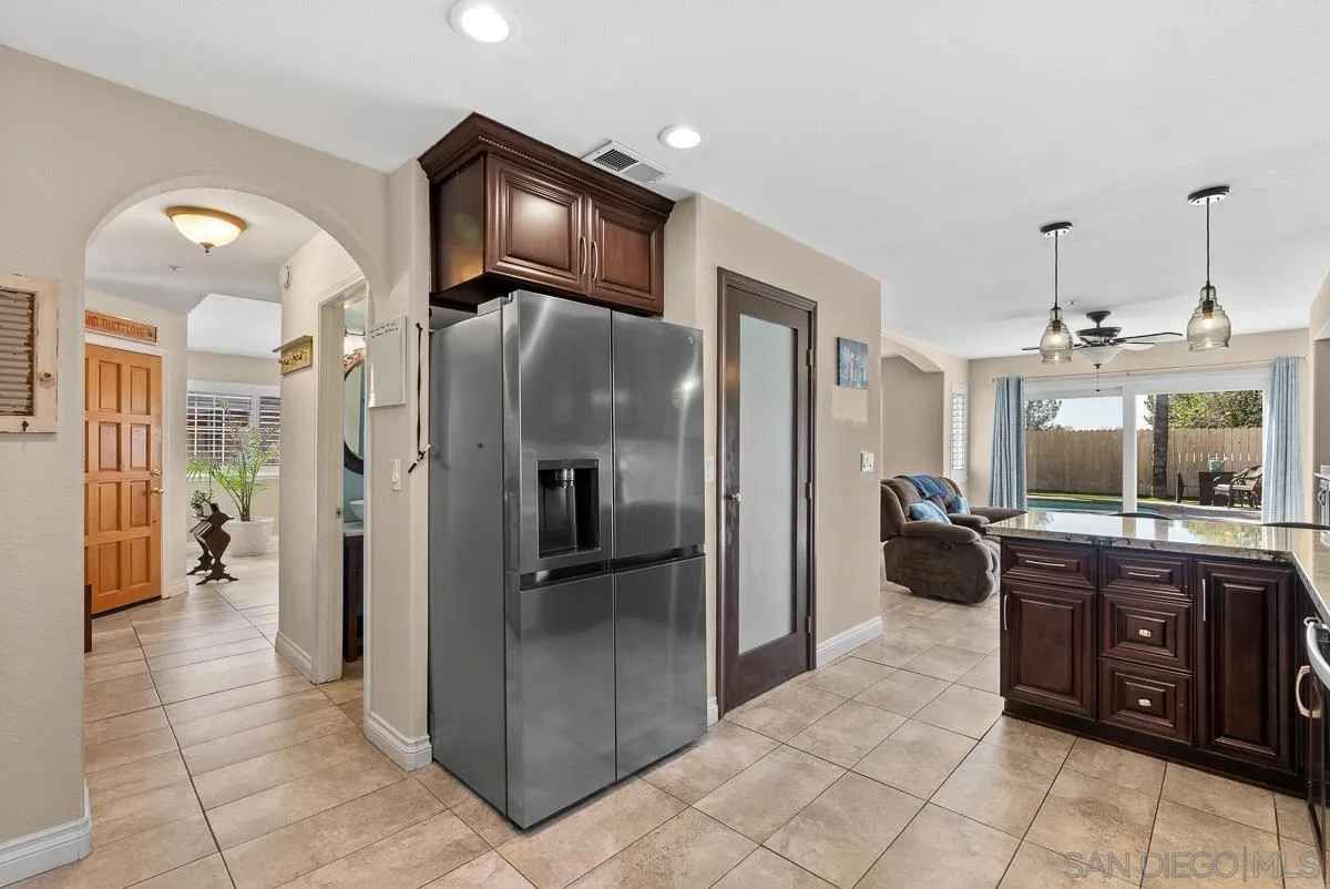 10109 Country Scenes Court Santee, CA 92071 - Photo 11 of 43 a kitchen with stainless steel appliances granite countertop a refrigerator and a sink