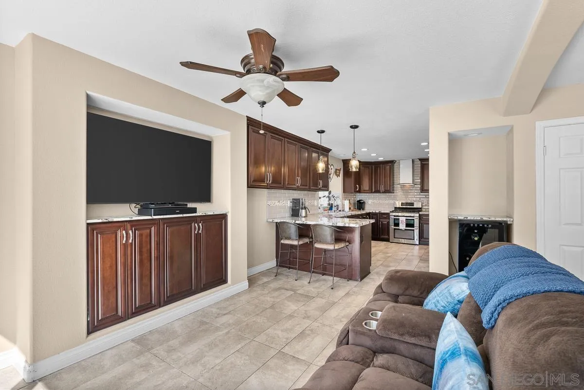 10109 Country Scenes Court Santee, CA 92071 - Photo 13 of 43 a living room with stainless steel appliances furniture and a flat screen tv