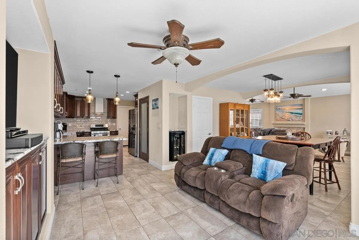 10109 Country Scenes Court Santee, CA 92071 - Photo 14 of 43 a living room with stainless steel appliances kitchen island granite countertop furniture and a view of kitchen