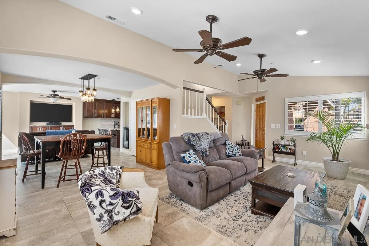 10109 Country Scenes Court Santee, CA 92071 - Photo 16 of 43 a living room with furniture and a flat screen tv with kitchen view