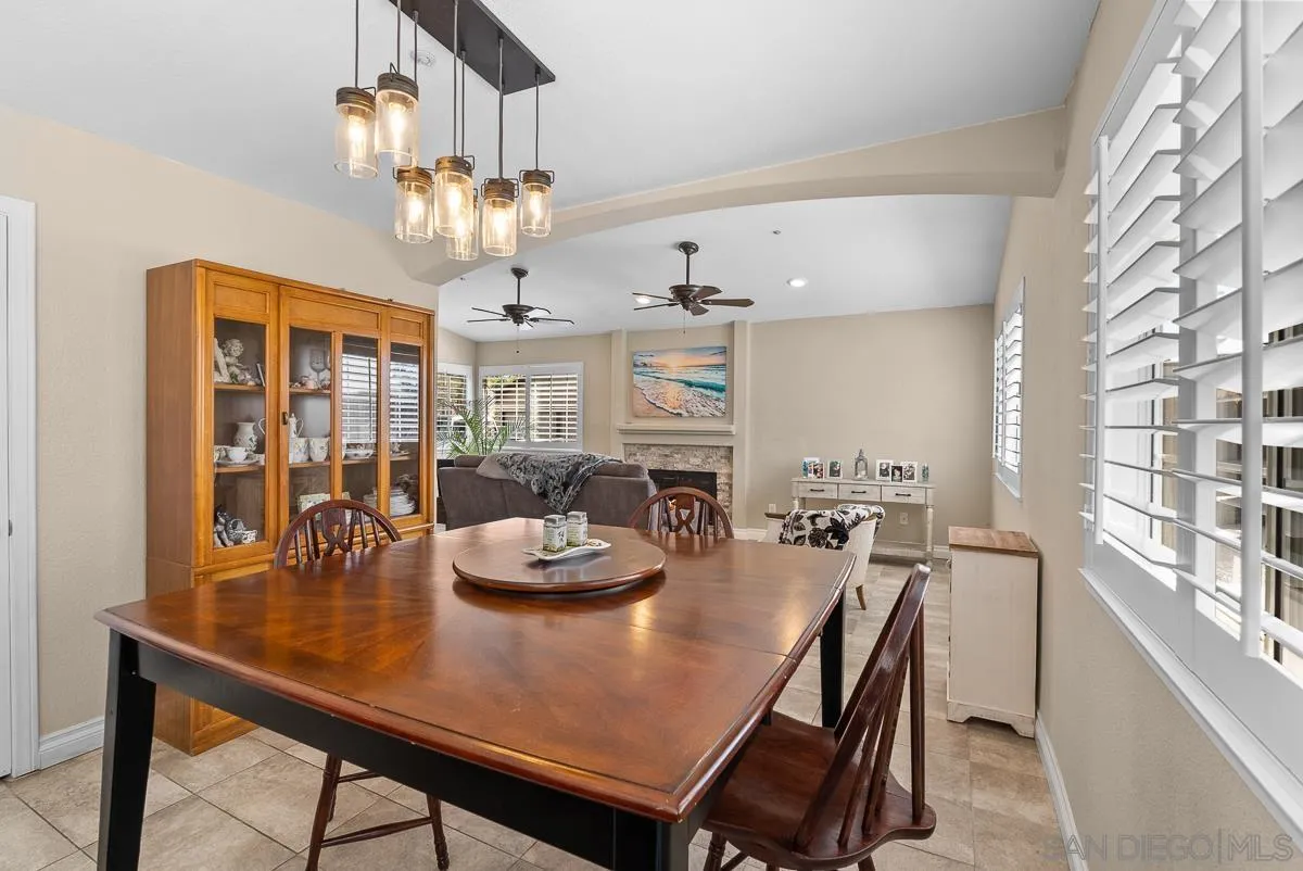 10109 Country Scenes Court Santee, CA 92071 - Photo 19 of 43 a view of a dining room with furniture a chandelier and large window