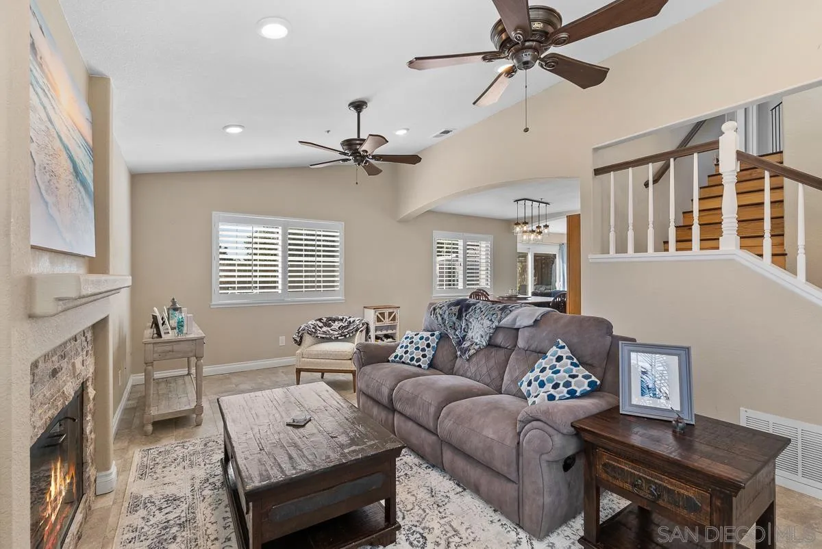 10109 Country Scenes Court Santee, CA 92071 - Photo 20 of 43 a living room with furniture a fireplace and a chandelier