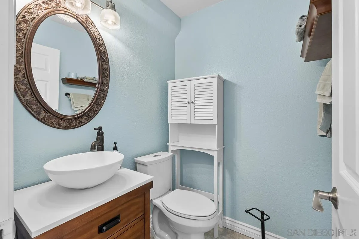 10109 Country Scenes Court Santee, CA 92071 - Photo 22 of 43 a bathroom with a toilet a sink and a mirror